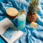 Finished Blue Hawaii mocktail next to printed recipe card