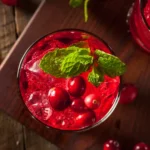 mocktail cranberry juice with ice, cranberries, and mint